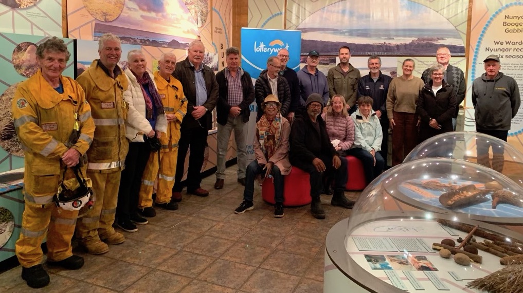 People gathered in a room displaying Aboriginal Artifacts